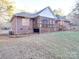 Brick house with a screened porch and backyard at 121 Sierra Woods Dr, Troutman, NC 28166