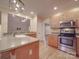 Modern kitchen with stainless steel appliances and hardwood floors at 121 Sierra Woods Dr, Troutman, NC 28166