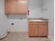 Laundry room with wooden cabinets and shelving at 121 Sierra Woods Dr, Troutman, NC 28166