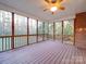 Spacious screened porch with wooden deck and ceiling fan at 121 Sierra Woods Dr, Troutman, NC 28166