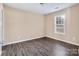 Bright bedroom with wood-look floors and window with blinds at 13502 Tartarian Ct, Charlotte, NC 28215