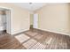 Primary bedroom with wood-like floors and ensuite bathroom at 13502 Tartarian Ct, Charlotte, NC 28215