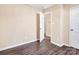 Bedroom with wood-look floors and access to hallway at 13502 Tartarian Ct, Charlotte, NC 28215