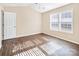 Bright bedroom with wood-look floors and large windows at 13502 Tartarian Ct, Charlotte, NC 28215