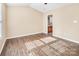 Bedroom with wood laminate flooring and access to bathroom at 13502 Tartarian Ct, Charlotte, NC 28215