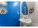 Small powder room with pedestal sink and blue walls at 13883 Clayborn St, Midland, NC 28107