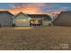 Backyard view of home with screened porch at sunset at 1410 Tranquility Blvd, Lancaster, SC 29720