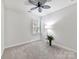 Bright bedroom with ceiling fan, window, and neutral decor at 1410 Tranquility Blvd, Lancaster, SC 29720