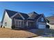 Beautiful two-story home with green siding, stone accents, and a two-car garage at 1410 Tranquility Blvd, Lancaster, SC 29720