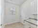 Convenient laundry room with a sink and cabinet storage at 1410 Tranquility Blvd, Lancaster, SC 29720