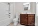 Bathroom with tub, shower, and dark brown vanity at 153 Crownpiece St, Troutman, NC 28166