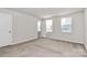 Well-lit bedroom with neutral walls and carpet flooring at 153 Crownpiece St, Troutman, NC 28166