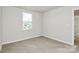 Bright bedroom with carpeted floors and a window at 153 Crownpiece St, Troutman, NC 28166