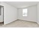 Well-lit bedroom with carpeted floor and window at 153 Crownpiece St, Troutman, NC 28166