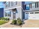 Two-story house with gray siding, a white garage door, and landscaping at 153 Crownpiece St, Troutman, NC 28166