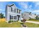 Two-story house with gray siding, black shutters, and landscaping at 153 Crownpiece St, Troutman, NC 28166