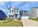 Two-story home with gray siding and a two-car garage at 153 Crownpiece St, Troutman, NC 28166