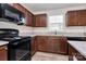 Modern kitchen with black appliances and granite countertops at 153 Crownpiece St, Troutman, NC 28166