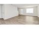 Bright living room featuring laminate flooring and a window at 153 Crownpiece St, Troutman, NC 28166