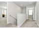 Upstairs hallway with carpeted floors and access to bedrooms at 153 Crownpiece St, Troutman, NC 28166