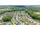 Aerial view of a residential neighborhood with houses, trees, and a lake in the background at 17527 Austins Creek Dr, Charlotte, NC 28278