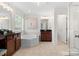 Large bathroom with soaking tub, double vanity, and shower at 17527 Austins Creek Dr, Charlotte, NC 28278