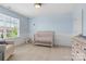 Light-filled Bedroom features a crib, dresser, and glider at 17527 Austins Creek Dr, Charlotte, NC 28278