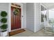 Front porch with rocking chair and red door at 17527 Austins Creek Dr, Charlotte, NC 28278