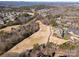 Aerial view of a golf course with clubhouse and residential neighborhood at 17527 Austins Creek Dr, Charlotte, NC 28278