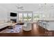 Bright living room with fireplace, hardwood floors, and ample natural light at 17527 Austins Creek Dr, Charlotte, NC 28278