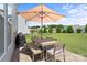 Patio with table, chairs, umbrella, and grill at 17527 Austins Creek Dr, Charlotte, NC 28278