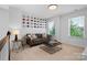 Cozy sitting area with a brown leather couch and a coffee table at 17527 Austins Creek Dr, Charlotte, NC 28278