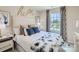 Bright bedroom with a queen-size bed and window seat at 1804 Otter Perch Ln, Fort Mill, SC 29715