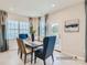 Bright dining area with a wooden table and blue chairs, near sliding door at 1804 Otter Perch Ln, Fort Mill, SC 29715