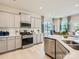 Modern kitchen with white cabinets, stainless steel appliances, and a large island at 1804 Otter Perch Ln, Fort Mill, SC 29715