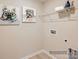 Clean laundry room with shelving and dog-themed art at 1804 Otter Perch Ln, Fort Mill, SC 29715