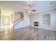 Living room with fireplace, hardwood floors and adjacent staircase at 18618 The Commons Blvd, Cornelius, NC 28031