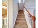 Carpeted staircase with wooden railing leading to the upper level at 18618 The Commons Blvd, Cornelius, NC 28031