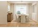 Bright dining room with a wooden table, white chairs, and built-in storage at 1984 Copper Path Dr, Fort Mill, SC 29715