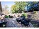 Landscaped backyard with stone retaining walls and a flagstone patio at 19914 Wooden Tee Dr, Davidson, NC 28036