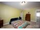 Simple bedroom with double bed, carpet flooring, and built-in dresser at 19914 Wooden Tee Dr, Davidson, NC 28036