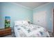 Bedroom with light blue walls, a queen bed, and double doors at 19914 Wooden Tee Dr, Davidson, NC 28036