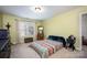 Bright bedroom with a double bed, carpet flooring, and a window with curtains at 19914 Wooden Tee Dr, Davidson, NC 28036