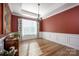 Formal dining room with red walls, hardwood floors, and a chandelier at 19914 Wooden Tee Dr, Davidson, NC 28036