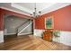 Formal dining room with red walls, hardwood floors, and a chandelier at 19914 Wooden Tee Dr, Davidson, NC 28036