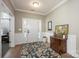 Bright entryway with hardwood floors, white wainscoting, and a wooden console table at 19914 Wooden Tee Dr, Davidson, NC 28036