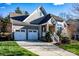 Gray two-story house with stone accents, two-car garage, and landscaped yard at 19914 Wooden Tee Dr, Davidson, NC 28036