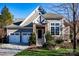 Gray two-story house with stone accents, two-car garage, and landscaped yard at 19914 Wooden Tee Dr, Davidson, NC 28036