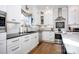 White kitchen with stainless steel appliances and subway tile backsplash at 19914 Wooden Tee Dr, Davidson, NC 28036