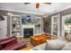 Living room boasts a fireplace and built-in shelving at 19914 Wooden Tee Dr, Davidson, NC 28036